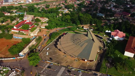 Aerial-view-rotating-away-from-the-Basilica-of-Mary-Queen-of-Apostles,-in-sunny-Cameroon