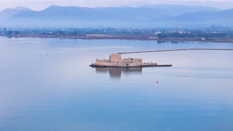 Rotating-Aerial-View-of-the-Majestic-Water-Castle-of-Bourtzi-in-the-Beautiful-Peloponnese-Region,-Greece