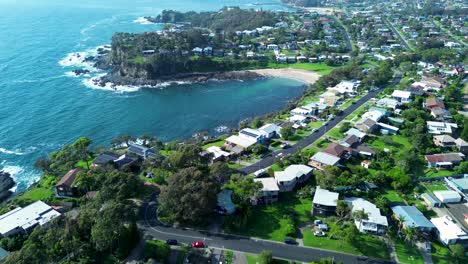 Drone-aerial-landscape-of-residential-housing-suburb-street-and-beach-headland-travel-tourism-Malua-Bay-Rosedale-South-Coast-Australia-NSW