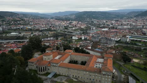 Catholic-seminary-religious-school-ontop-hill-overlooking-city-of-Ourense-Galicia-Spain-aerial-orbit