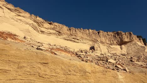 Camera-trucking-right-on-imposing-sunny-cliffs