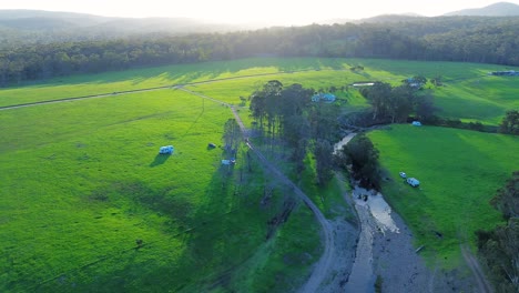 Drone-aerial-farmland-campsite-with-muddy-track-meadow-bushland-property-campervan-Eden-Nethercote-South-Coast-travel-tourism-Australia-4K