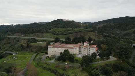 Aerial-parallax-of-Catholic-seminary-religious-school-as-car-drives-down-leaving-to-Ourense