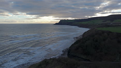 Establishing-Drone-Shot-of-North-Yorkshire-Coast-Cliffs-at-Sunrise-UK