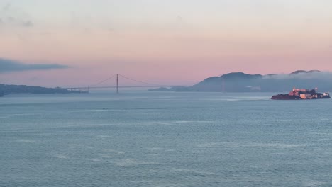 Wide-aerial-view-of-Alcatraz-Island-and-Golden-Gate-Bridge,-USA-at-Sunrise