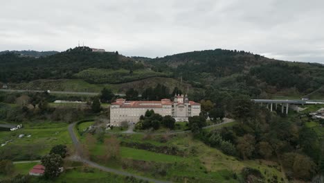 Drone-orbits-around-Catholic-seminary-religious-school-on-hill-in-mountains-of-Ourense