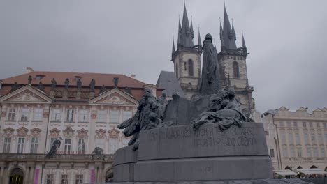 Jan-Hus-Memorial-in-Prague's-Old-Town-Square-with-the-Church-of-Our-Lady-before-Týn-in-the-background