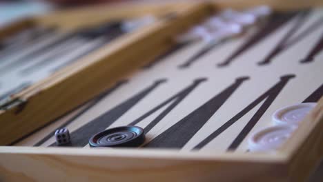 Backgammon-Game-Wooden-Board-Close-Up-with-Dices-being-Rolled,-Slow-Motion