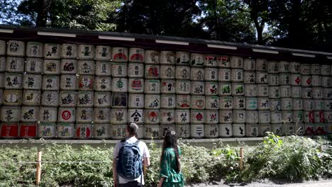 Wall-of-sake-barrels-at-the-Meiji-Shrine-in-Tokyo,-Japan-tourist-attraction