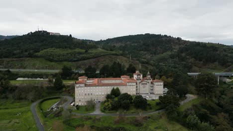 Frontal-pan-across-winding-road-leading-to-Catholic-seminary-religious-school-in-Ourense