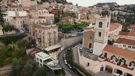 Drone-flying-backward-in-Taormina's-old-town-which-is-built-on-a-mountain