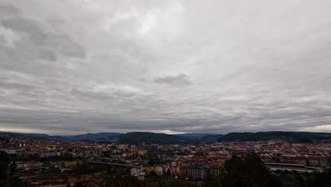 Clouds-rush-over-historic-city-of-Ourense-Galicia-Spain-as-cars-drive-along-highway-and-road
