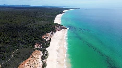 Drone-aerial-coastline-landscape-Pinnacles-bushland-national-park-sandy-ocean-beach-Sapphire-Coast-travel-tourism-Merimbula-Eden-NSW-Australia-4K