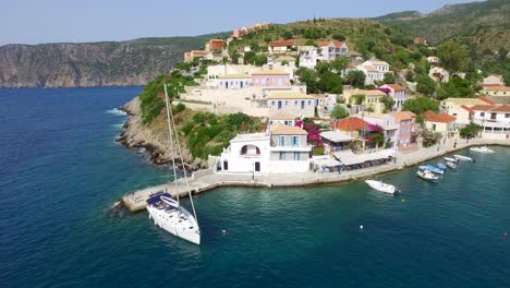 Drone-shot-retreating-and-panning-to-the-left-side-of-the-frame-of-a-peninsula-at-Agriosiko-Beach,-a-secret-getaway-located-in-the-island-of-Kefalonia-in-Western-Greece