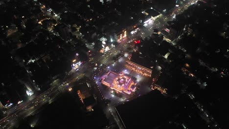 Rajkot-aerial-drone-view-Wide-angle-drone-scene-where-the-temple-is-glowing-with-lighting-and-many-high-rise-buildings-are-visible-around