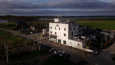 Sunlight-fades-out-of-Dutch-white-factory-building-resulting-in-a-dark-and-ominous-image