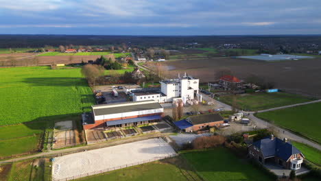 Drone-orbit-around-Dutch-beer-brewery-in-sunlight-Limburg-Netherlands-landscape