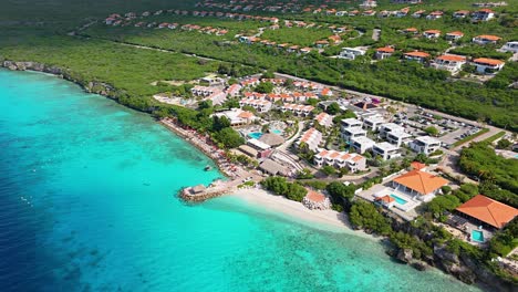 Panoramic-aerial-establishing-overview-of-Karakter-beach-and-luxury-resort-estate-behind
