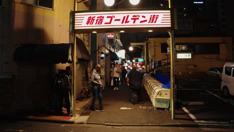Slow-motion-pan-of-Golden-Gai-in-Shinjuku,-People-visiting-small-bars-and-enjoying-night