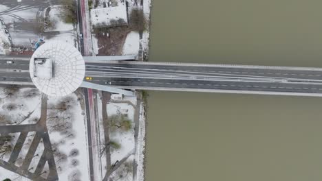 Aerial-drone-top-down-view-of-yellow-taxi-cab-on-SNP-bridge-above-Danube-river