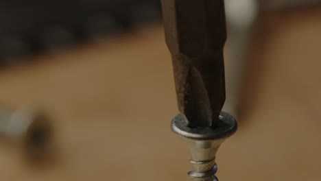 Macro-view-of-electric-screw-driver-drill-bit-drilling-screw-in-slow-motion