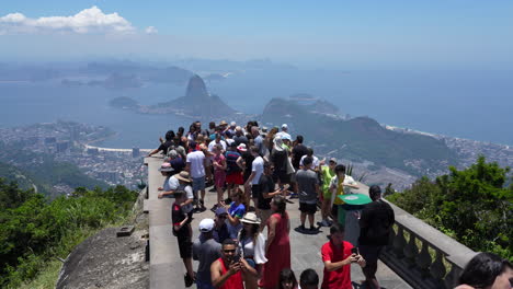 Tourists-at-Christ-The-Redeemer-viewpoint,-panoramic-views-over-Rio-de-Janeiro