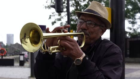 Man-Playing-Trumpet-on-City-Streets