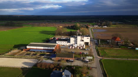 Dramatically-lit-Hertog-Jan-beer-factory-in-Dutch-Limburg-landscape-aerial