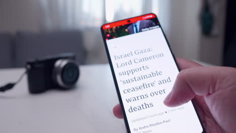 Nahaufnahme-Eines-Mobilen-Smartphones,-Mit-Dem-Eine-Person-Im-Internet-Nach-Den-Neuesten-Nachrichten-über-Die-Geschehnisse-In-Gaza-Und-Den-Andauernden-Krieg-Zwischen-Israel-Und-Der-Hamas-Sucht