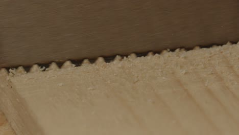 Macro-view-of-saw-sawing-into-board-of-wood