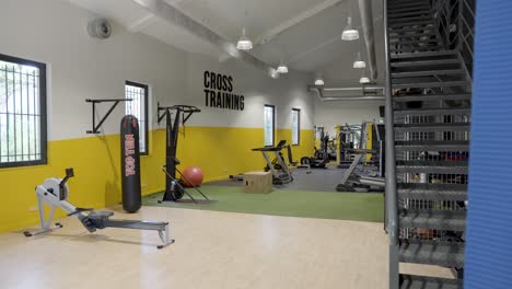 Empty-fitness-space-with-fitness-equipment,-boxing-bag,-cardio-machines,-Cross-training