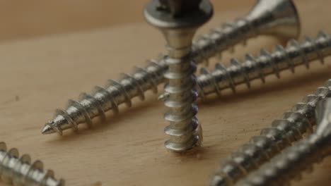 Macro-close-up-of-Metal-screw-drilled-into-wooden-beam