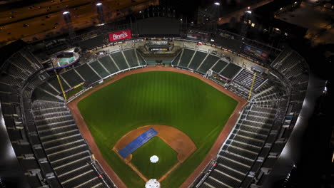 Drone-tilting-above-the-Guaranteed-Rate-Field-stadium,-winter-night-in-Chicago