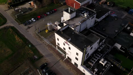 Top-crane-down-of-white-Hertog-Jan-beer-factory-with-logo-in-white-building