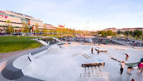Urban-skate-park-with-skaters-and-ramps-at-sunset-in-Vilus