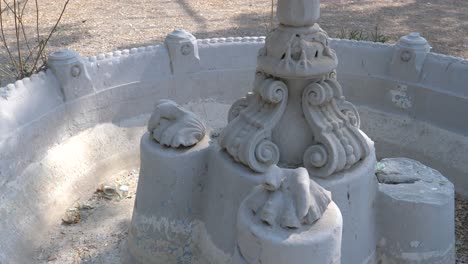 Closeup-shot-of-a-base-of-white-marble-fountain-during-daytime-at-Goolbai-Maternity-Home-in-Karachi,-Pakistan