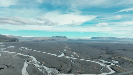 Aerial-View-Of-River-Flowing-Through-Lava-Field-Near-Vatnajokull-Glacier-In-South-Iceland