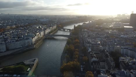 Drone-filming-sunrise-on-river-seine-in-paris,-bridges,-magical-light-of-dawn