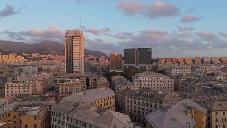 Aerial-Drone-Pan-Above-Sunset-Skyline-of-Liguria,-Italy,-Genoa-Historic-Town