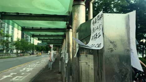 Illegal-leaflets-pasted-on-roadside-walls-in-Hong-Kong,-China