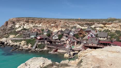 Popeye-Village,-Malta:-4K-Reveal-of-Cinematic-Set,-Unique-Architecture,-and-Turquoise-Waters