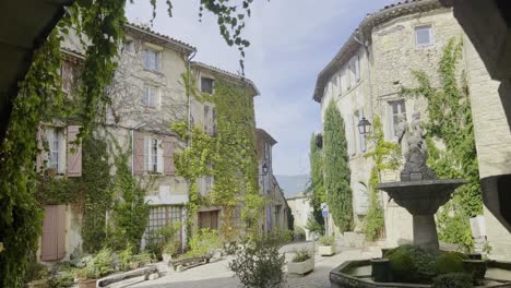 historic-small-market-square-in-an-old-village-in-France-with-many-old-stone-houses-in-good-weather