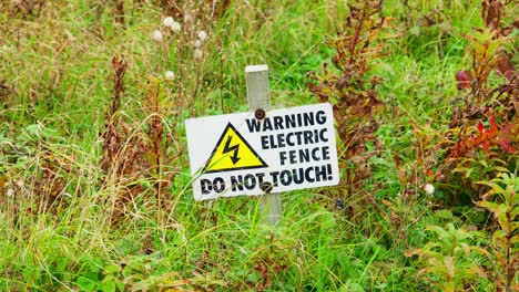 Warning-sign-placed-in-the-ground-to-let-people-know-the-danger-posed-by-the-electric-fence