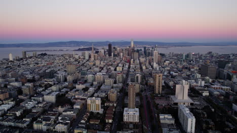 Flying-over-the-cityscape-of-San-Francisco,-dawn-in-CA,-USA---pull-back,-drone-shot