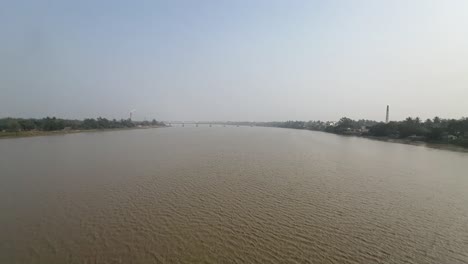 Ultra-wide-cinematic-shot-of-a-calm-muddy-river-during-daytime-in-Bengal,-India