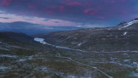 Ascent-over-the-Gamle-Strynefjellsvegen-with-a-magnificent-blue-and-red-sunset-in-the-background