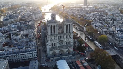 Orbital-movement-filmed-with-a-drone-in-front-of-the-Notre-Dame-Church-in-Paris-during-dawn,-magical-light,-Senna-River-in-the-background