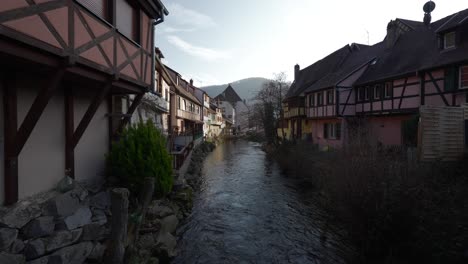 Weiss-river-stream-through-Kaysersberg,-France,-the-medieval-town-with-half-timbered-architecture