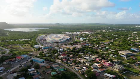 Panoramic-aerial-establishing-dolly-of-large-mall-on-Caribbean-island-of-Curacao-at-sunset
