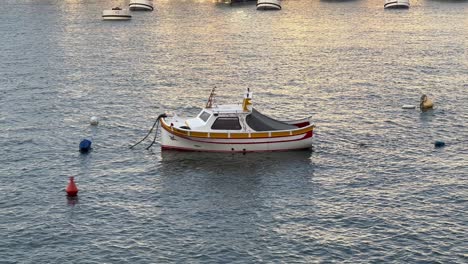4K-Handheld-Shot-of-a-Motorised-Fishing-Boat-in-Vittoriosa-Yacht-Marina,-Malta